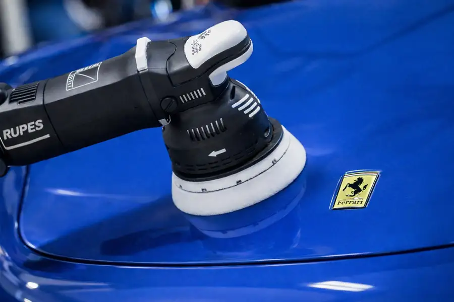 Machine polishing a car before ceramic coating