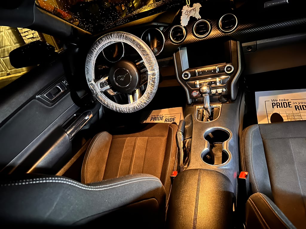 Ford Mustang interior AFTER full detail by Detail Jockey — clean suede seats, polished carbon dash