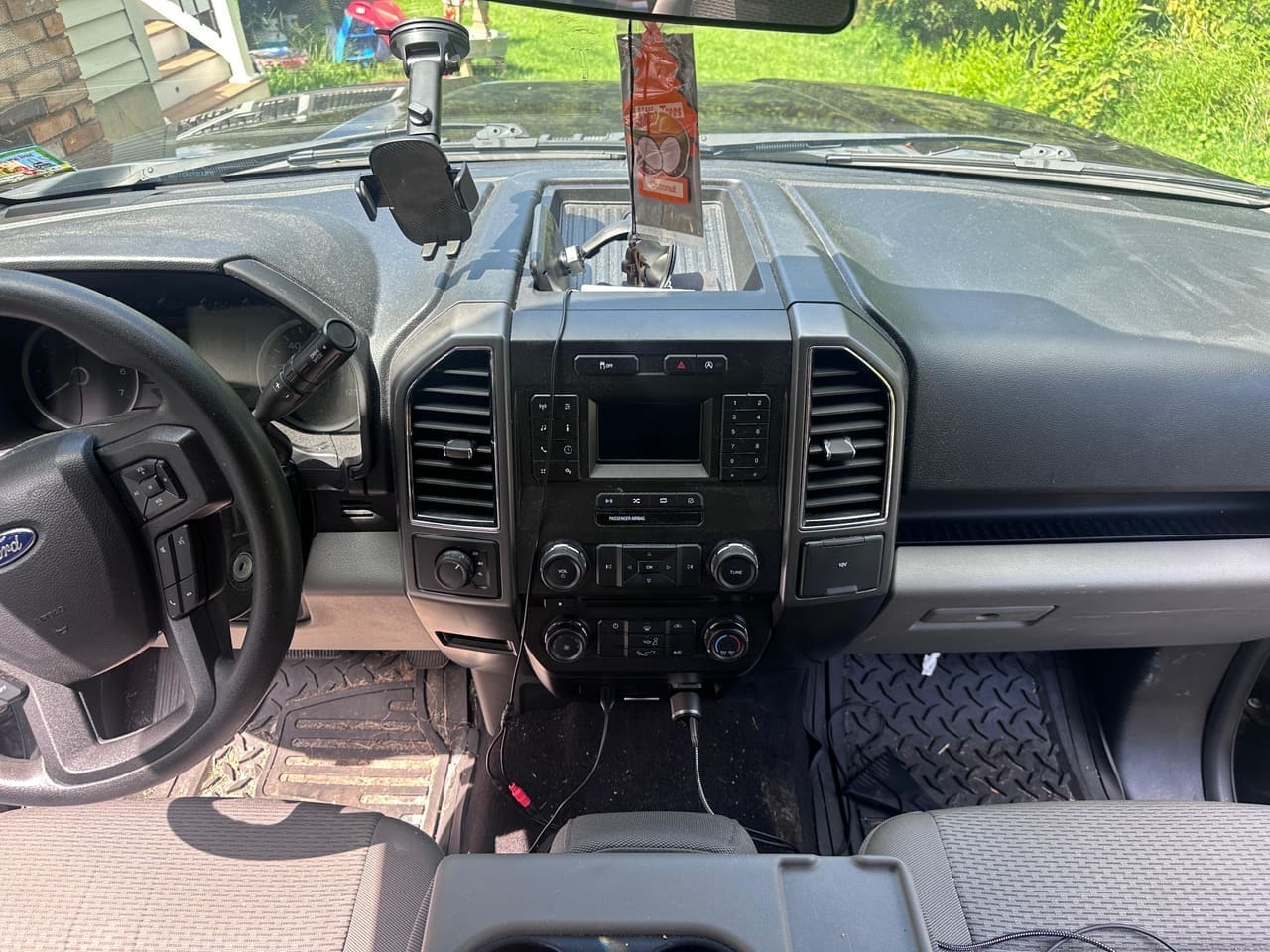 Ford F-150 dashboard BEFORE detail — hazy, dust-covered dash and console, Flemington NJ