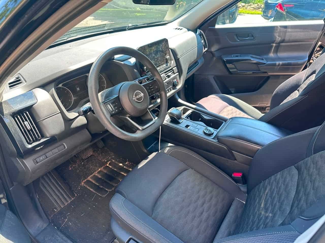 SUV interior BEFORE detail — pine needles and debris packed into the floor mats, Flemington NJ