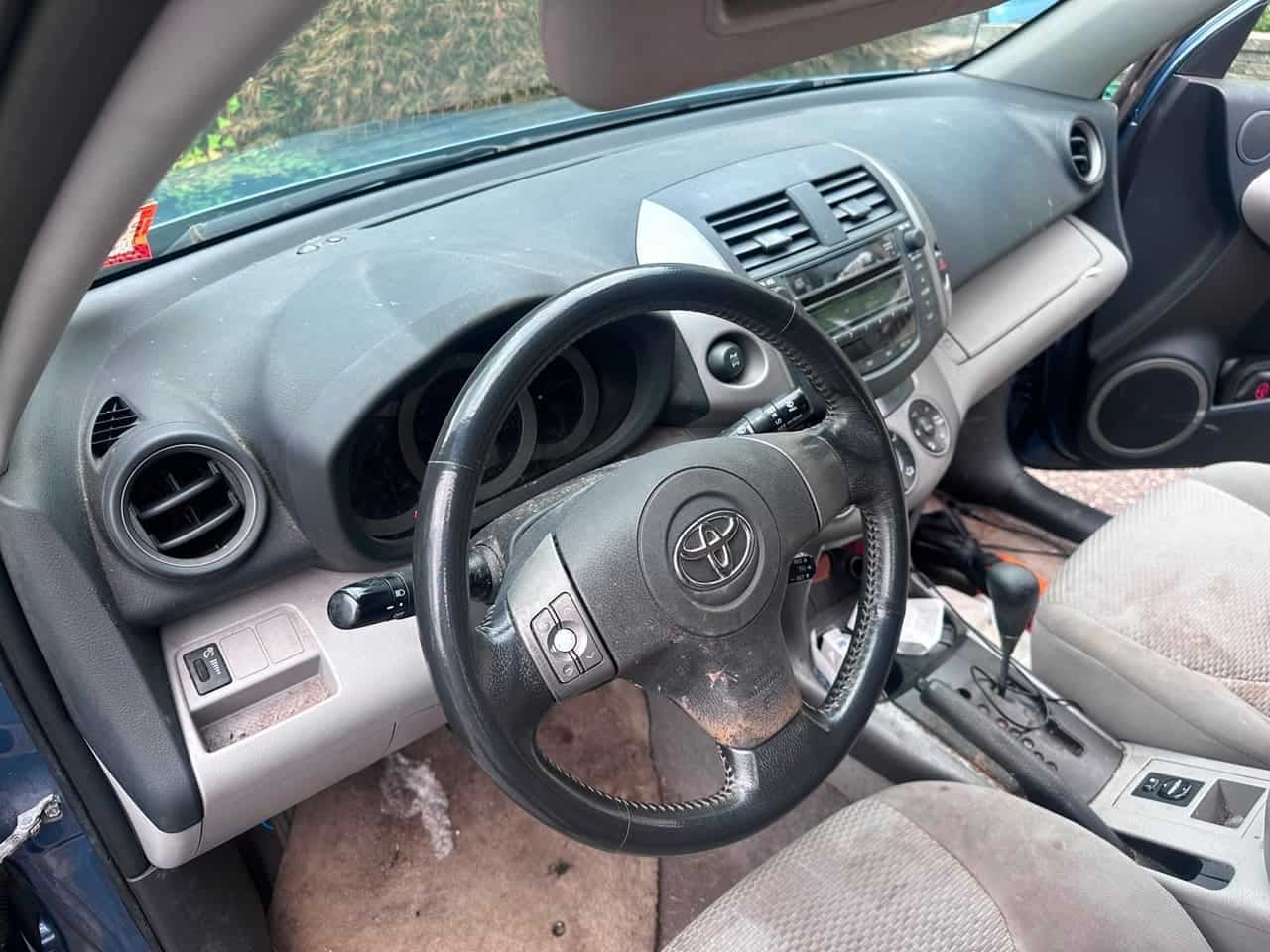 SUV interior BEFORE detail — dusty dashboard and worn steering wheel, Flemington NJ