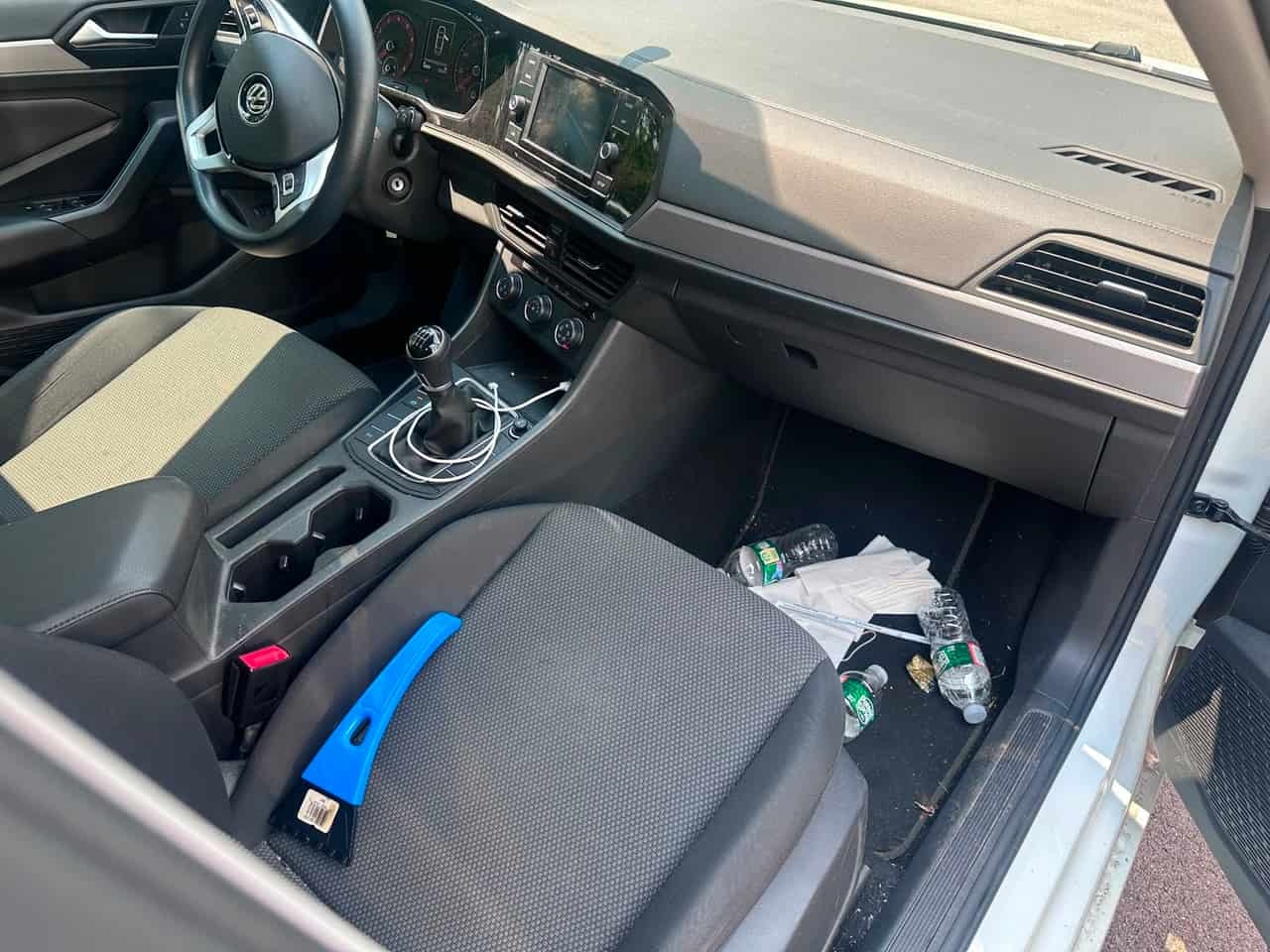 Before interior detailing — bottles and trash across the front floorboard, Flemington NJ