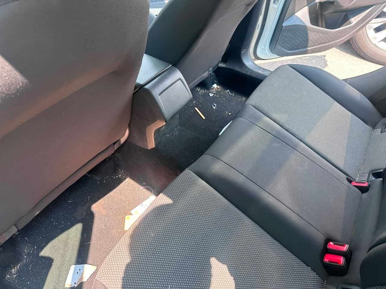 Sedan rear seats BEFORE detail — debris scattered across the rear floor, Flemington NJ