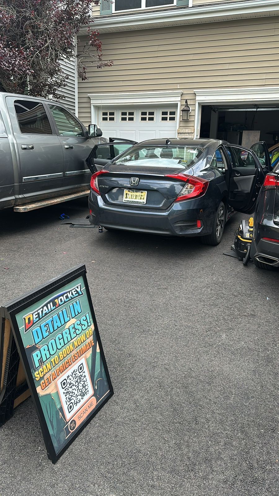 Detail Jockey mobile detailing in progress at customer driveway in Flemington NJ — Detail in Progress sign, multiple vehicles being serviced