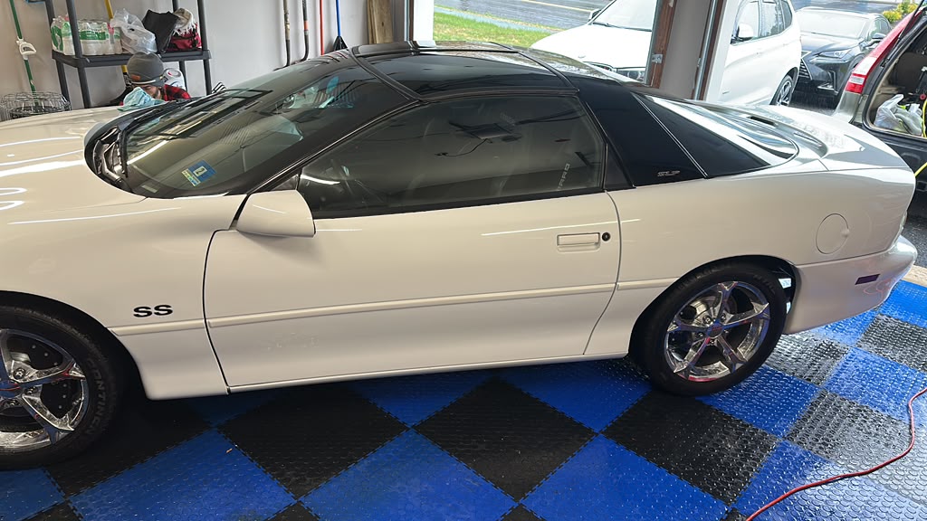 White Chevrolet Camaro SS exterior side profile after full detail by Detail Jockey — glossy paint, clean chrome wheels, Flemington NJ