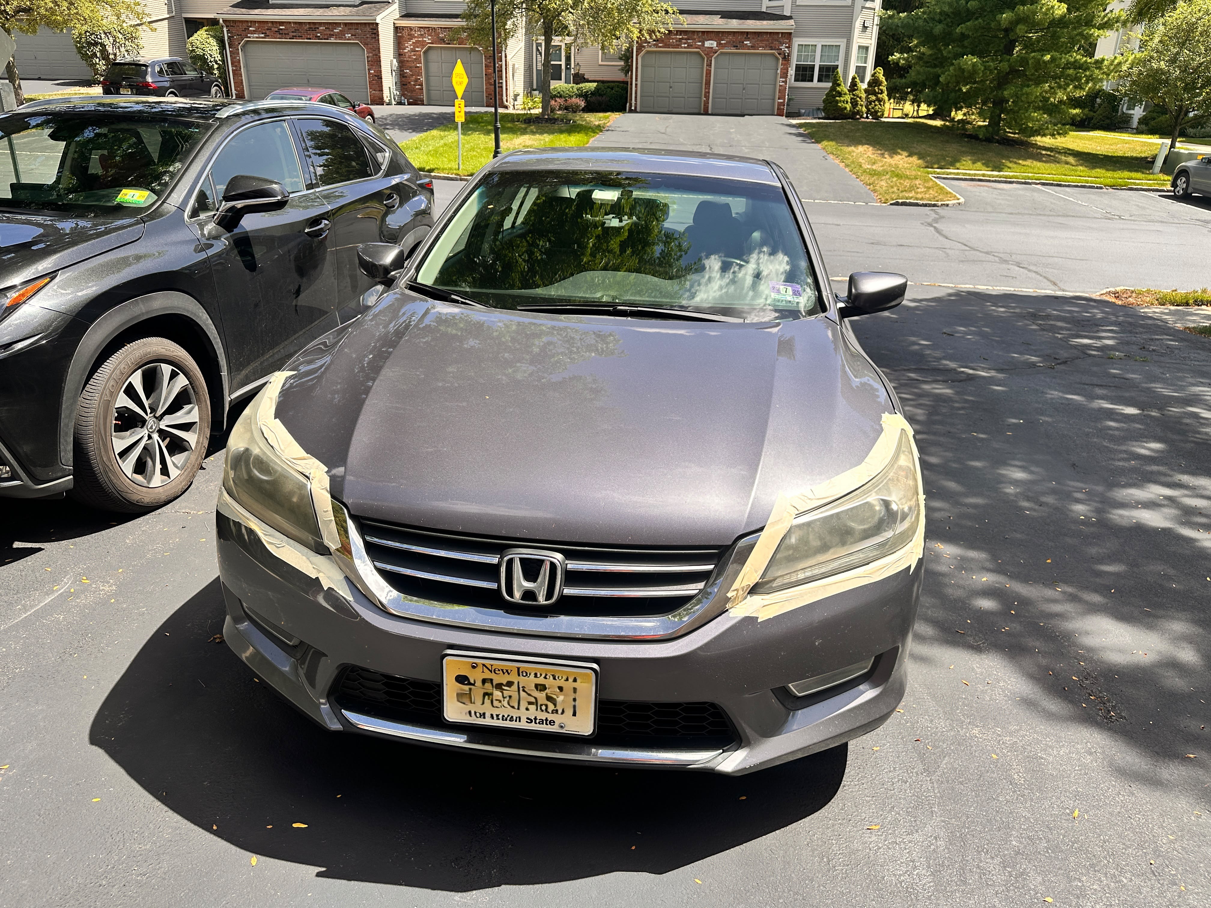 Front view before headlight restoration — Honda Accord with both headlights taped off, Flemington NJ