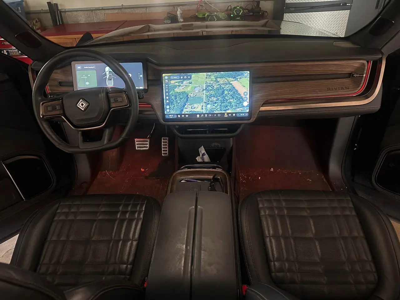 Rivian R1T interior BEFORE detail — dirt and debris on the front floor, dusty center console, Flemington NJ